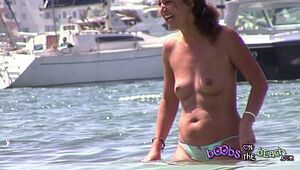 MILF Hippy getting wet on beach with camel toe and nice finger lickin boobies